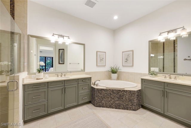 bathroom with tile patterned flooring, vanity, and plus walk in shower