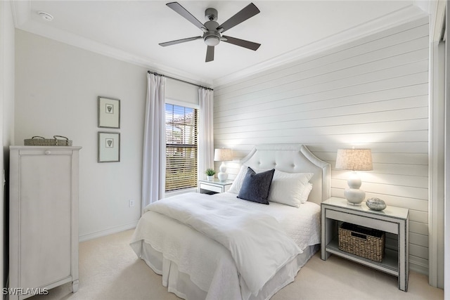 bedroom featuring light carpet, ornamental molding, and ceiling fan