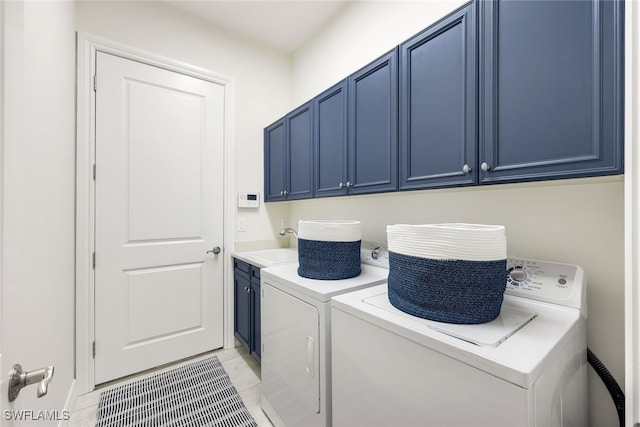 laundry area featuring cabinets, washer and clothes dryer, sink, and light tile patterned floors