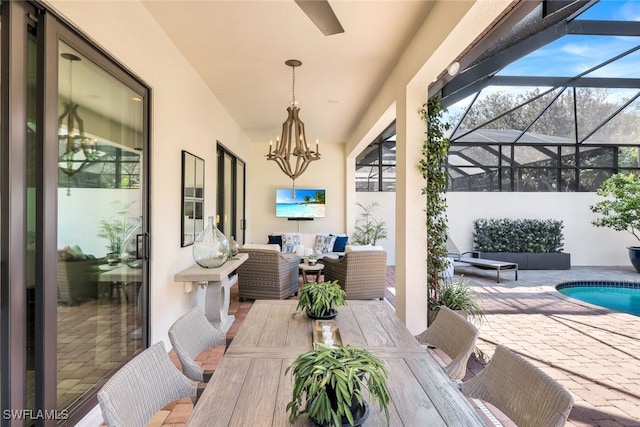 view of patio / terrace with an outdoor hangout area and glass enclosure