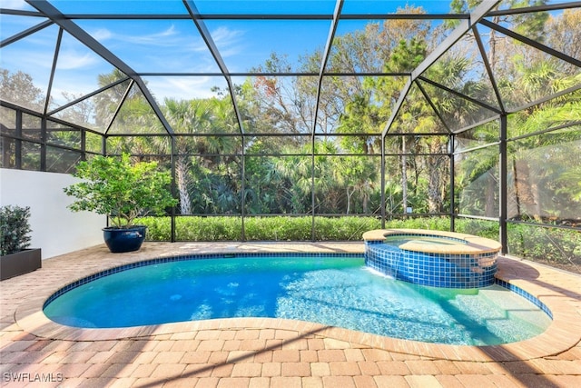 view of pool featuring an in ground hot tub, a lanai, and a patio