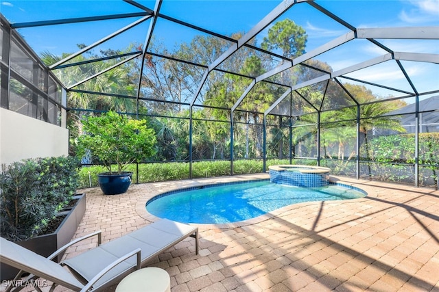 view of swimming pool featuring an in ground hot tub, a patio area, and glass enclosure