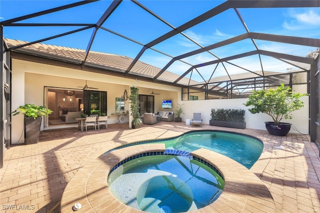 view of swimming pool with an in ground hot tub, ceiling fan, a lanai, and a patio area