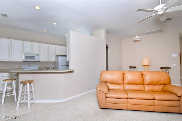 living room with ceiling fan and light carpet