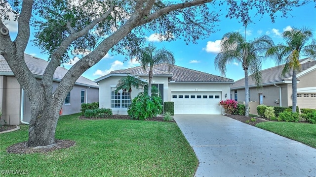 view of front of home with a garage and a front lawn