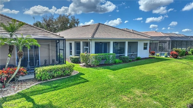 back of house featuring a yard and a sunroom