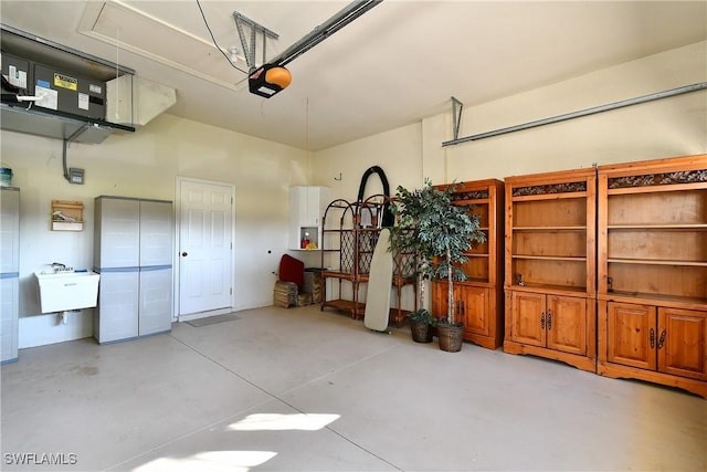 garage featuring sink and a garage door opener