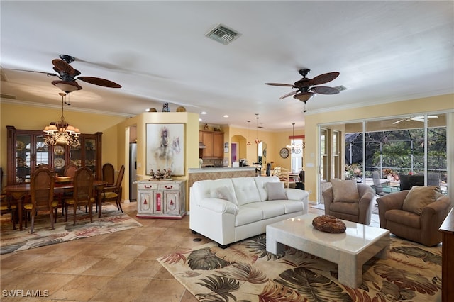 living room with ornamental molding and ceiling fan with notable chandelier