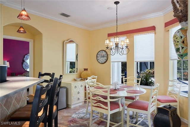 tiled dining room featuring a notable chandelier and ornamental molding