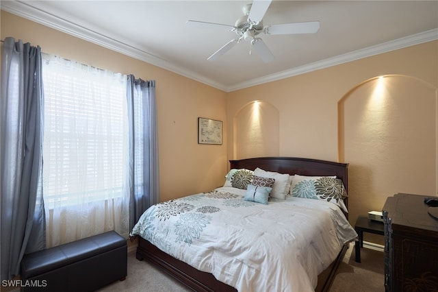 carpeted bedroom with crown molding and ceiling fan