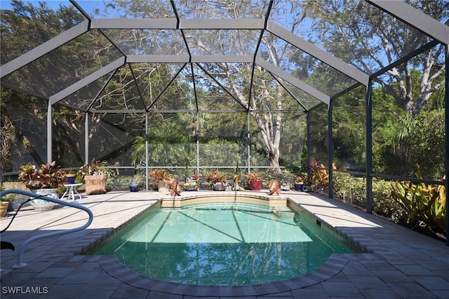 view of swimming pool featuring a patio and a lanai