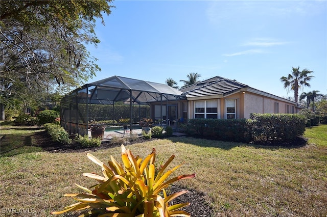 view of yard with glass enclosure