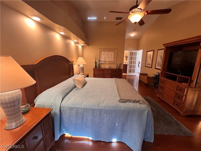 bedroom featuring ceiling fan, dark hardwood / wood-style floors, and vaulted ceiling