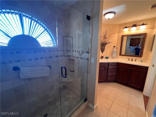 bathroom with vanity, tile patterned floors, and a shower with shower door