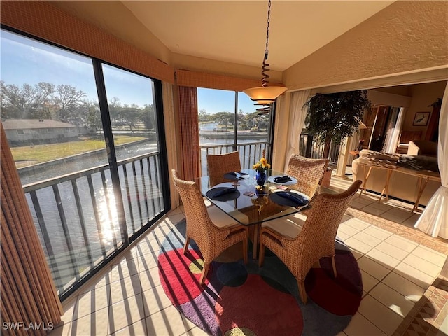 sunroom with a water view and lofted ceiling