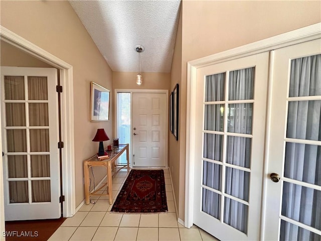 doorway to outside with light tile patterned flooring, vaulted ceiling, a textured ceiling, and french doors