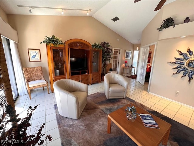 tiled living room with ceiling fan, track lighting, french doors, and a healthy amount of sunlight