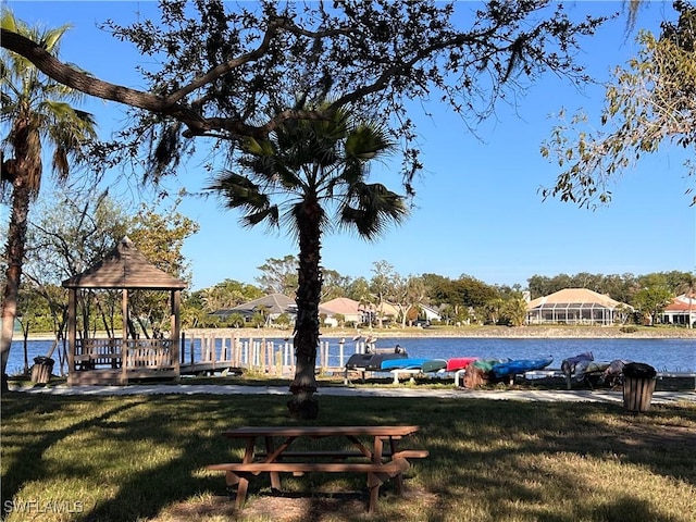 view of property's community featuring a yard, a gazebo, and a water view