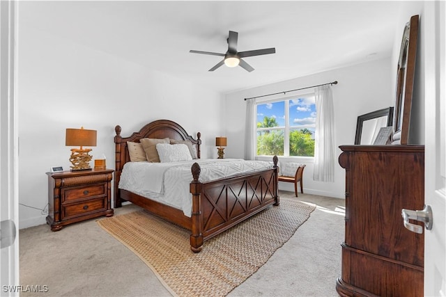 bedroom featuring ceiling fan and light colored carpet