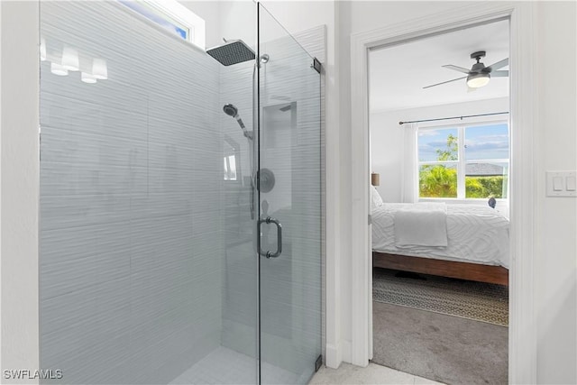 bathroom featuring ceiling fan and a shower with shower door