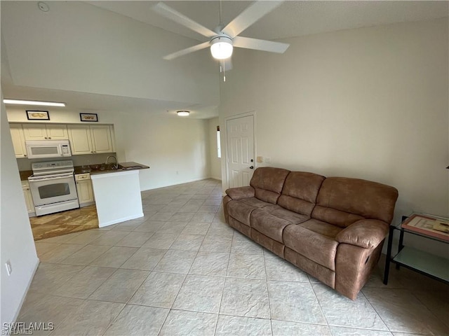 living room with ceiling fan, high vaulted ceiling, and sink