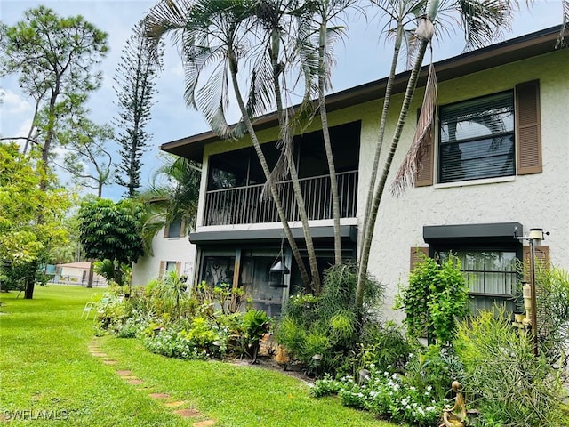 rear view of property featuring a yard