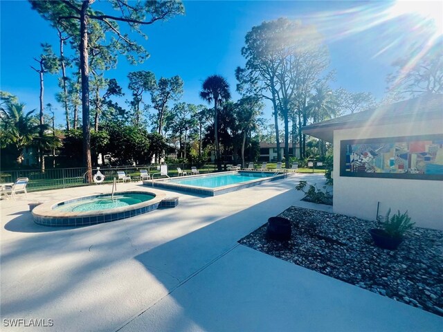 view of pool featuring a community hot tub and a patio