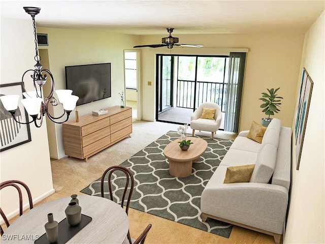 living room with light carpet, a ceiling fan, and baseboards