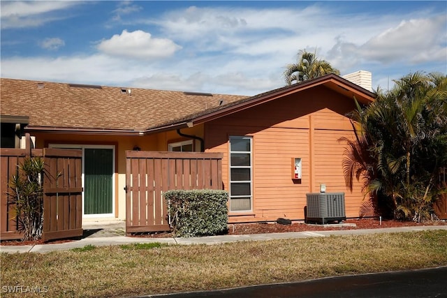 rear view of property featuring cooling unit