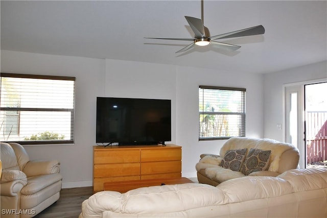 living room featuring ceiling fan and dark hardwood / wood-style flooring