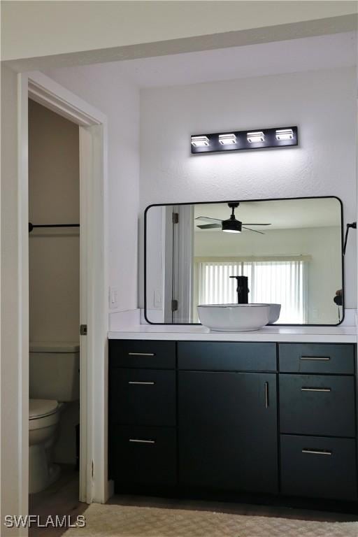 bathroom with vanity, ceiling fan, and toilet