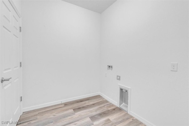 clothes washing area featuring light wood-type flooring, laundry area, baseboards, and electric dryer hookup