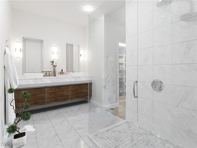 bathroom featuring a tile shower and vanity