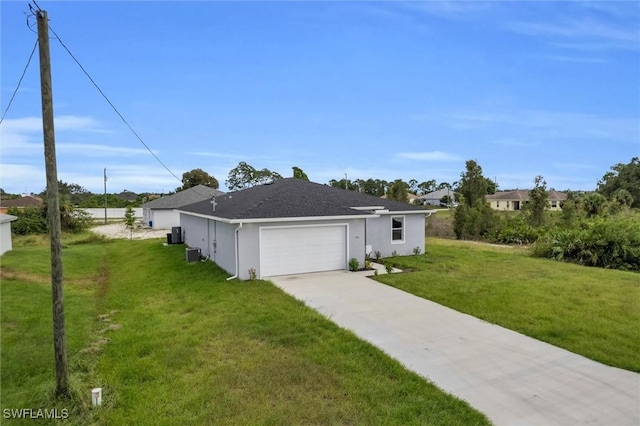 view of front of home featuring driveway, an attached garage, a front lawn, central AC, and stucco siding