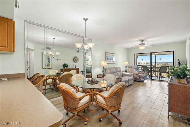 dining area featuring ceiling fan with notable chandelier