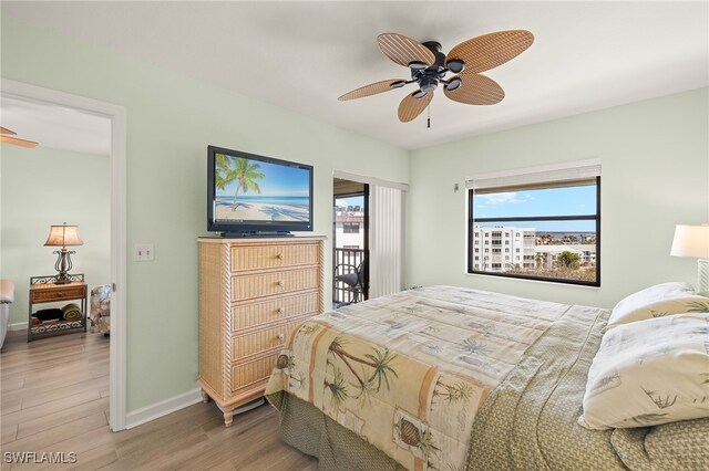 bedroom with wood-type flooring, access to outside, and ceiling fan