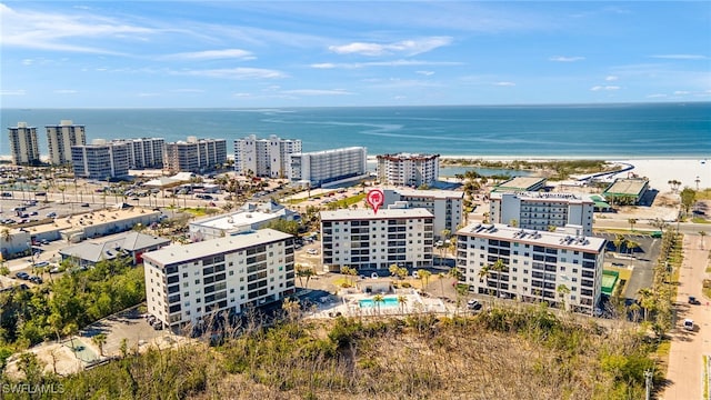 drone / aerial view featuring a water view and a view of the beach