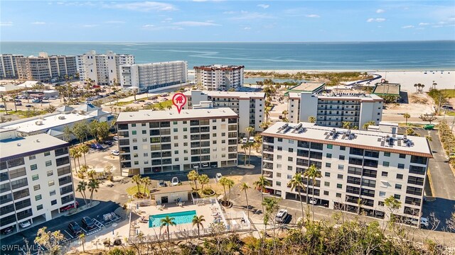 drone / aerial view with a water view and a beach view