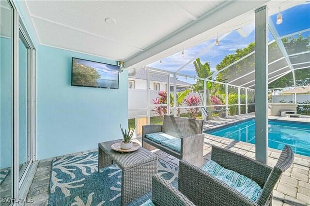 view of pool featuring an outdoor living space, a patio area, and glass enclosure