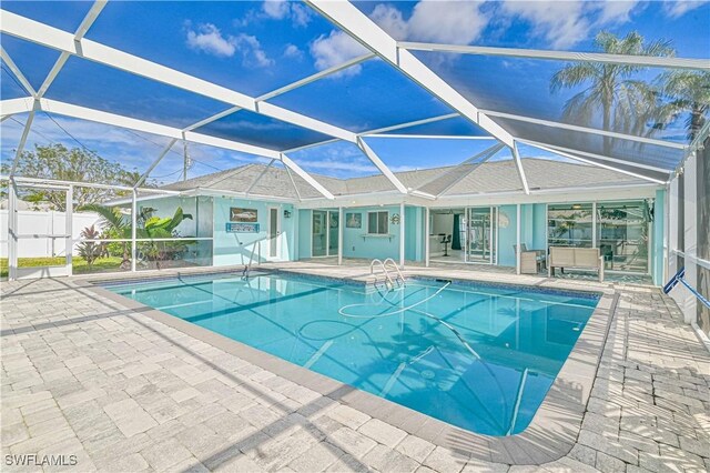 view of pool with a lanai and a patio area