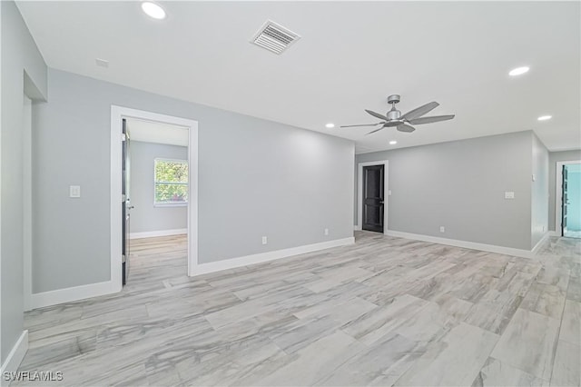 spare room featuring ceiling fan and light wood-type flooring