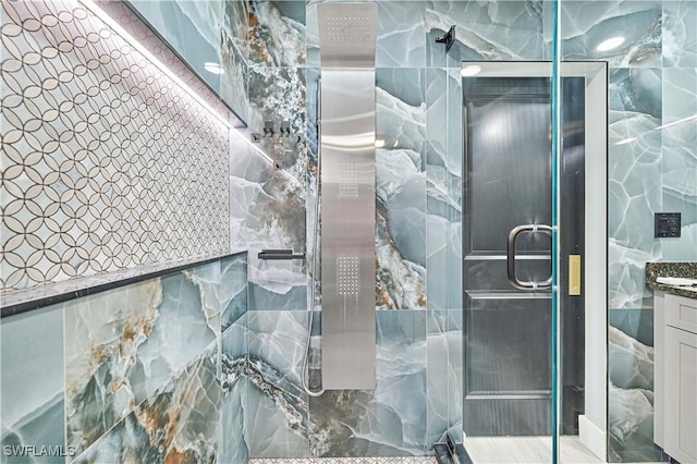 bathroom with vanity, tile walls, and an enclosed shower