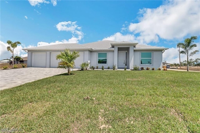 view of front of home featuring a garage and a front lawn