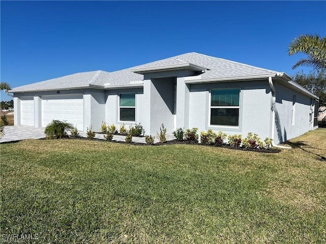 view of front of property with a garage and a front yard