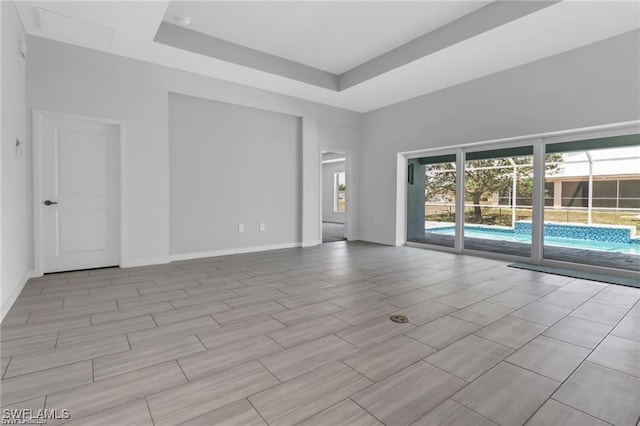 spare room featuring a raised ceiling