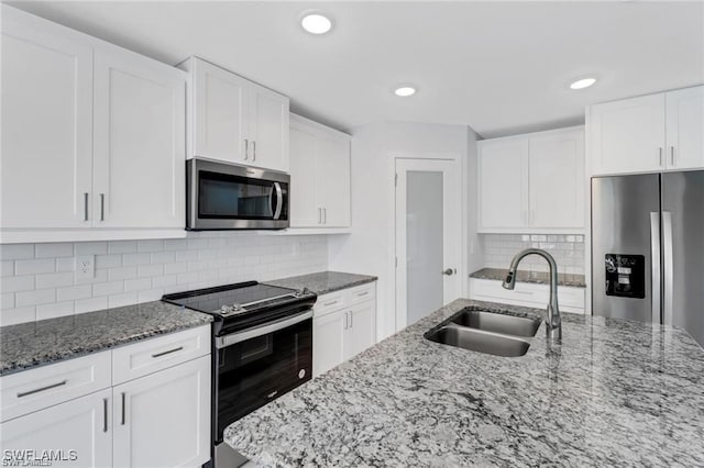 kitchen with sink, stainless steel appliances, and white cabinets