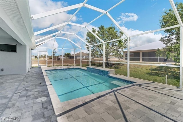 view of swimming pool featuring a lanai and a patio area