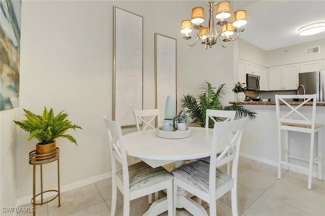 tiled dining space featuring an inviting chandelier