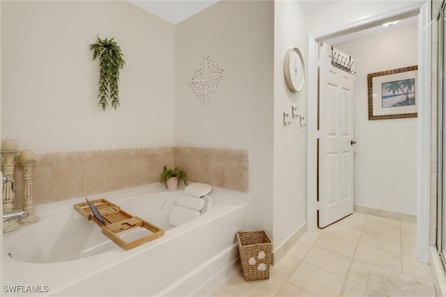 bathroom featuring a bath and tile patterned flooring