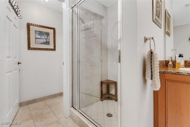 bathroom featuring walk in shower, vanity, and tile patterned flooring